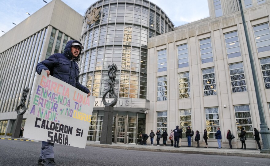 A protestor stands outside Federal court in Brooklyn on January 17 with a sign that says, "Calderon knew," referring to Former Mexican President Felipe's possible awareness that his top security minister, Genaro Garcia Luna, may have been in cahoots with the Sinaloa drug cartel.