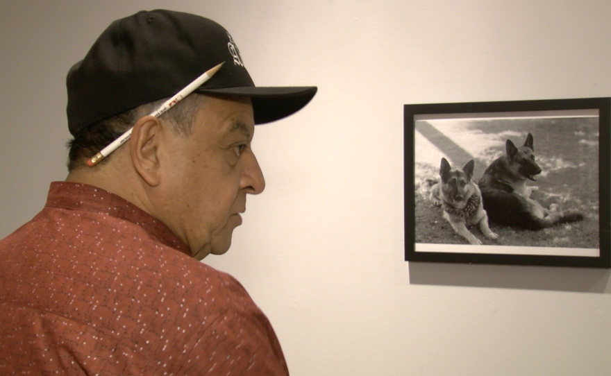 Carlos LeGerrette discusses his photographs at a new University of San Diego exhibit, Sept. 12, 2016.