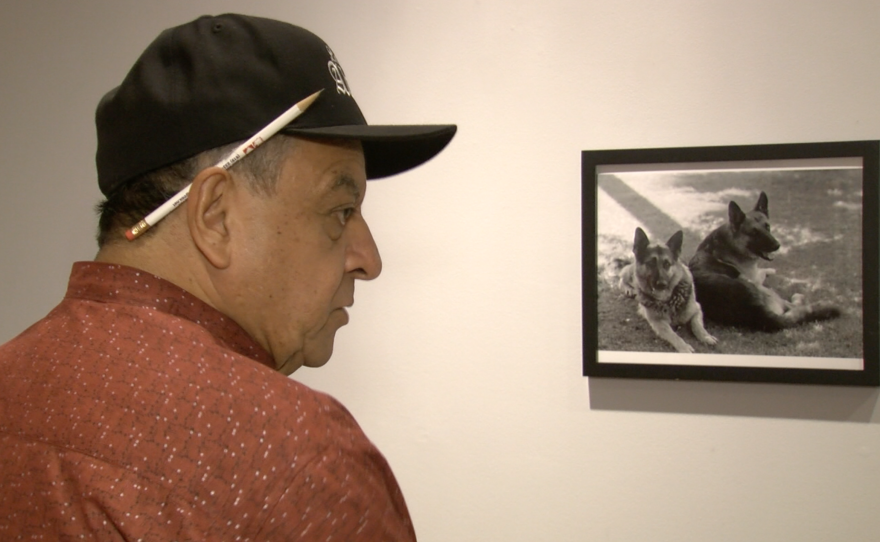 Carlos LeGerrette discusses his photographs at a new University of San Diego exhibit, Sept. 12, 2016. 