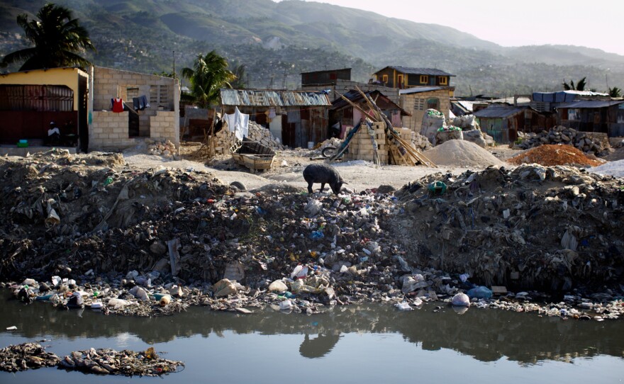 People dump trash and raw sewage into canals that run through Port-au-Prince, Haiti. When it rains, the canals overflow and flood poor neighborhoods.