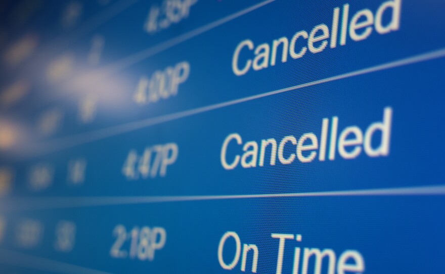 A flight information display system shows cancelled flights at the Ronald Reagan Washington National Airport on Dec. 27, 2021, in Arlington, Va. Flight cancellations became a regular occurrence in December as the omicron variant infected staff at airports and airlines.