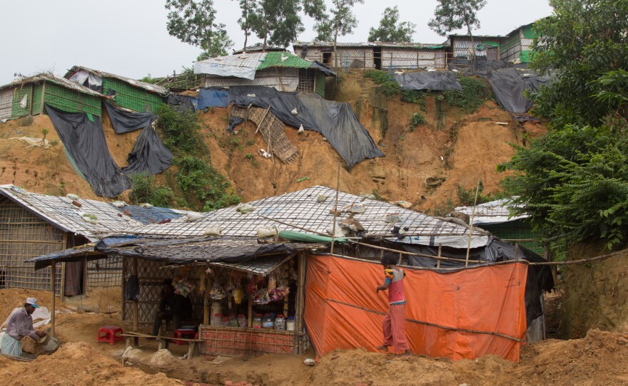 Shelters in the Balukhali refugee camp sit at the base of steep cliffs of sand.