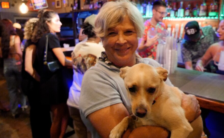 The Hole owner Karen Sherman is shown holding a four-legged friend at the bar on June 20, 2024.