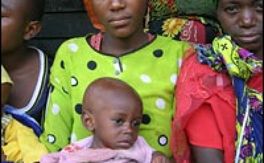 A woman holds a malnourished child in the remote village of Chambucha in the Democratic Republic of Congo.