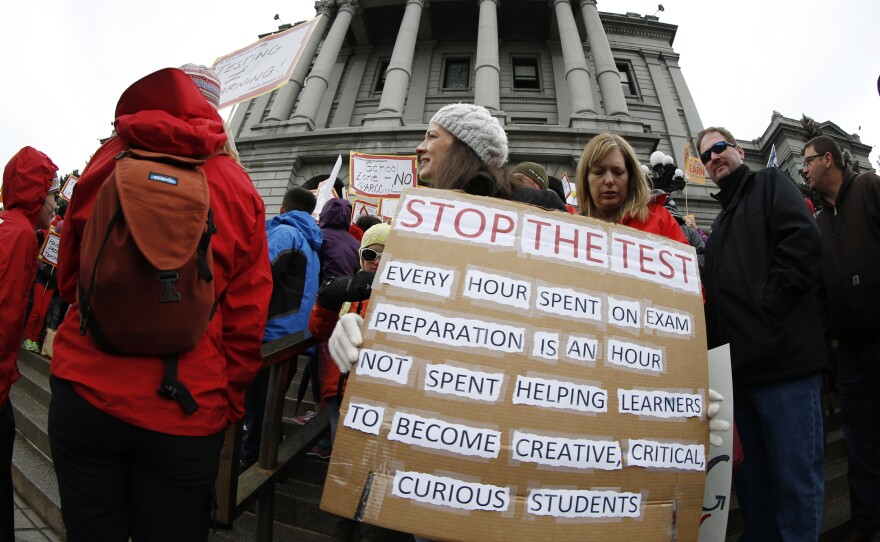 Colorado: Teacher Jen Shafer of Colorado Springs, Colo., waves a placard during a rally against what protesters called "excessive" standardized testing in Colorado schools on the west steps of the State Capitol in Denver.