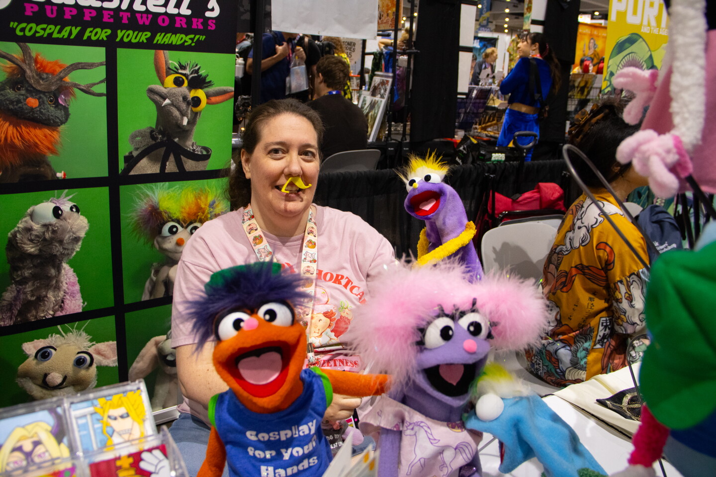 A puppeteer shows off puppets in a booth at Comic-Con, April 23, 2026.
