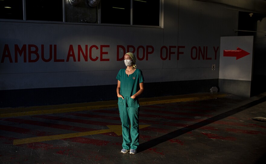 Emergency medical officer Dr. Storm Bissict, 35, photographed outside the ER entrance of Netcare Christiaan Barnard Memorial Hospital, Cape Town, South Africa, on the morning of January 19. To escape the stresses of her job during a pandemic, she dives into the ocean.