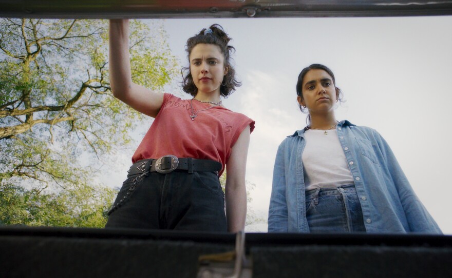 Margaret Qualley as "Jamie" and Geraldine Viswanathan as "Marian" in director Ethan Coen's "Drive-Away Dolls." (2024)