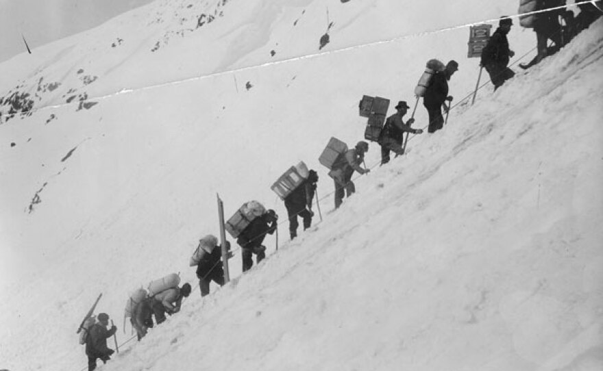 Klondikers carrying supplies ascending the Chilkoot Pass, 1900.