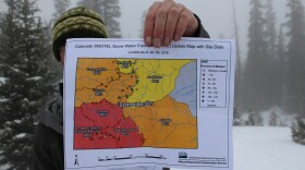 Hydrologist Karl Wetlaufer with the Natural Resources Conservation Service holds a map showing Colorado's low snowpack, January 9, 2018. 