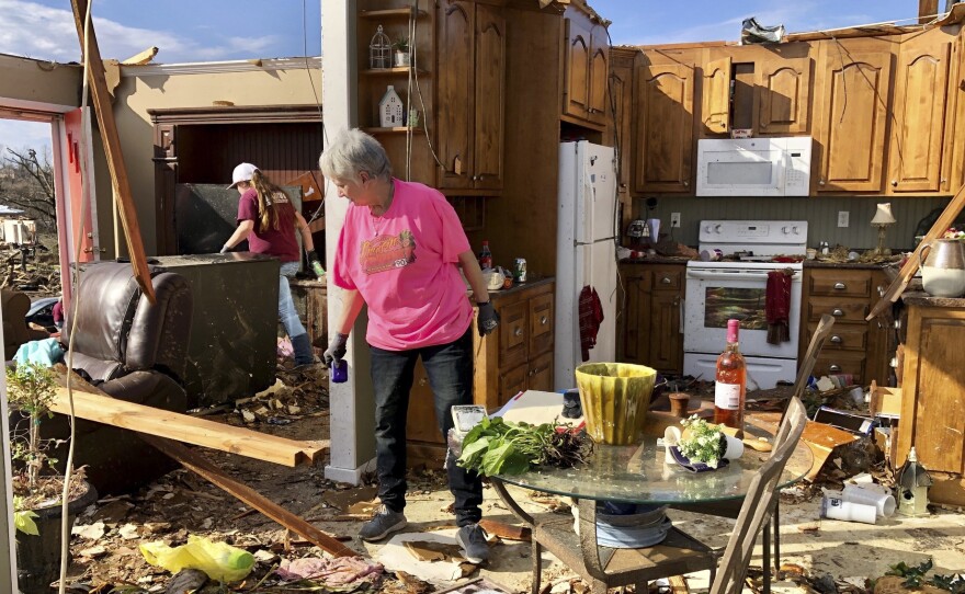 Patti Herring sobs as she sorts through the remains of her home in Fultondale, Ala., on Tuesday, after her house was destroyed by a tornado.