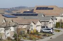 This file photo taken Wednesday, Feb. 12, 2020, shows solar panels on rooftops of a housing development in Folsom, Calif.