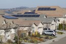 This file photo taken Wednesday, Feb. 12, 2020, shows solar panels on rooftops of a housing development in Folsom, Calif. 