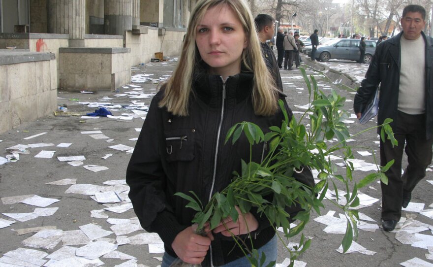 Dasha Vasilenko, 23, is a student in Bishkek. She supported the ouster of the president, but was disappointed that protests turned to looting. Here, she is holding a plant she found amid the debris in the general prosecutor's office. She's going to plant it at home to save it.