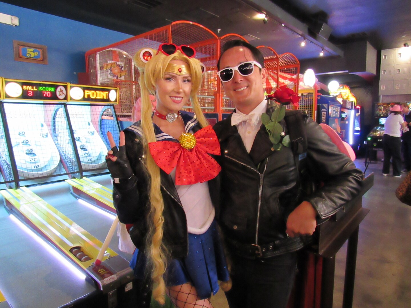 From left: Cherish and Valor McConnell dress as biker Sailor Moon and Tuxedo Mask at Coin-Op for the "Dungeon Crawler Carl" activation on July 26, 2025. 