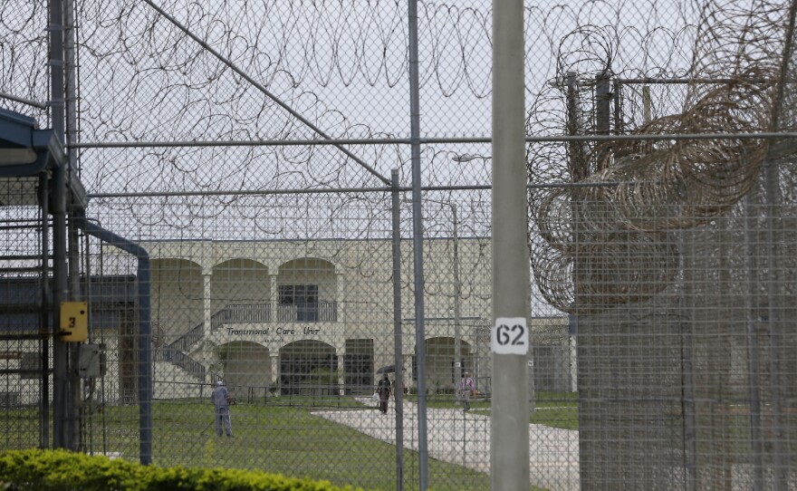 A prisoner works on the lawn at the Dade Correctional Institution In 2014, in Florida City, Fla. On Friday, Miami-Dade prosecutor Katherine Fernandez Rundle found no wrongdoing in the death of mentally ill prisoner Darren Rainey, who was locked in a shower stall at the Dade Correctional Institution in June 2012. He died after he was left unattended for two hours with the water running.