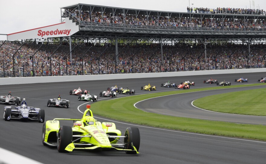 The Indianapolis 500 — usually viewed by hundreds of thousands of spectators — will be run in August in front of a crowd capped at 50% capacity, track officials say. Here, cars race in front of fans during last year's event.