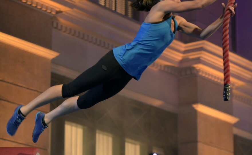 Intelligence officer Tory Garcia, who has a background in gymnastics and diving, works through the obstacle course on <em>American Ninja Warrior, </em>which airs on NBC and Esquire Network.