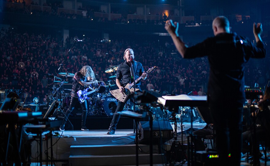 Metallica joined forces with the San Francisco Symphony for a spectacular concert. Guitarist James Hetfield (center). San Francisco Symphony conductor Edwin Outwater (right).