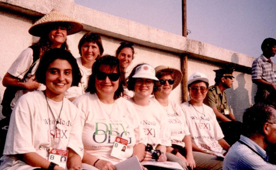 Anne Marie Goetz (back row, wearing traditional Chinese hat) takes in the welcoming ceremony for the 1995 U.N. conference for women, held at a stadium in Beijing.