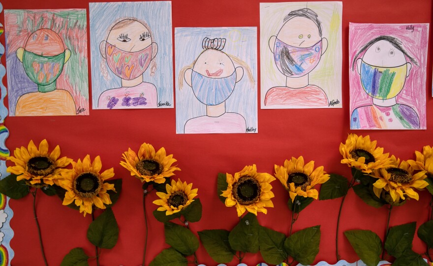 Drawings of children wearing masks adorn a hallway at Stark Elementary School on Sept. 16, 2020, in Stamford, Conn.