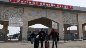 People at the Kapikoy border crossing between Turkey and Iran, in eastern Van province, Turkey, March 2.