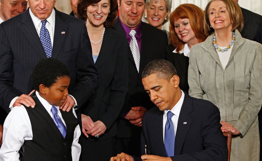 President Obama signs the Affordable Health Care for America Act during a ceremony with fellow Democrats, including Vice President Biden, Speaker of the House Nancy Pelosi, Senate Majority Leader Harry Reid, Sen. Ted Kennedy's widow, Victoria Kennedy, Health and Human Services Secretary Kathleen Sebelius, and Marcelas Owens (left) in the East Room of the White House on Tuesday.