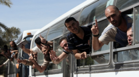 Palestinian prisoners pass the Rafah border crossing from Egypt into the Gaza Strip on Tuesday after they were released from Israeli jails as part of a landmark prisoner swap.