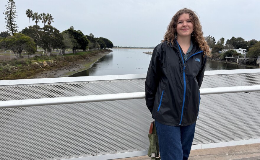 Savannah Stallings, with the San Diego Bird Alliance, stands on a bridge spanning Rose Creek as it flows into Mission Bay in San Diego. Dec. 31, 2025