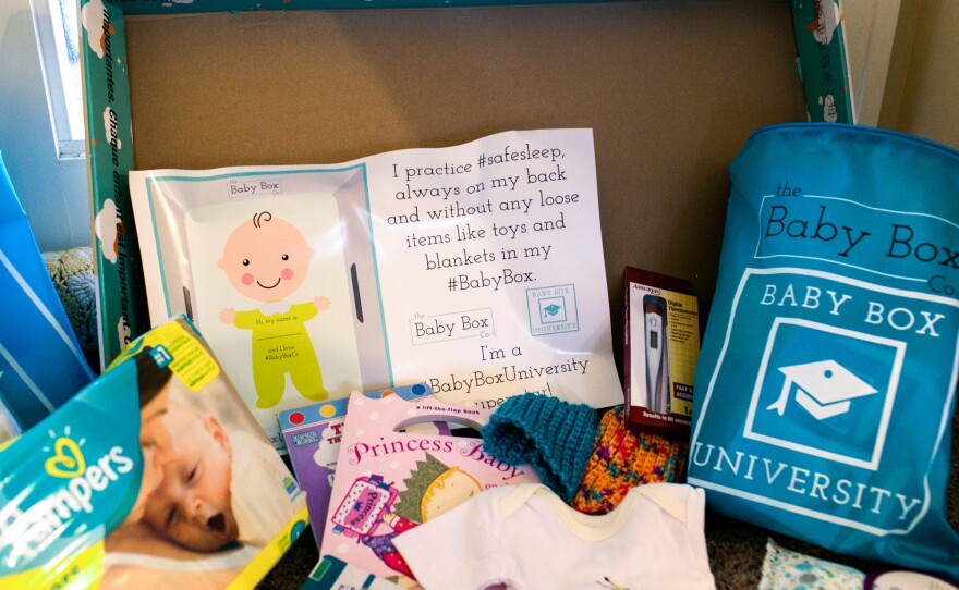 In Ohio, the free baby box comes with educational materials, books, diapers, wipes and clothes.