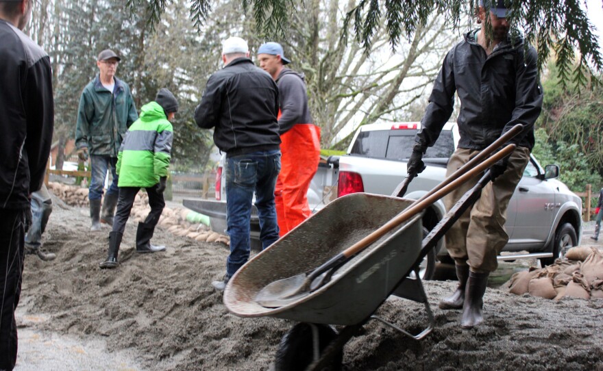 Volunteers and residents create flood barriers in a low-lying neighborhood of Abbotsford, British Columbia, on Nov. 28.