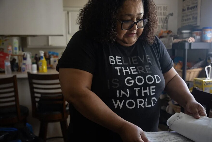 Kendra Sherman looks through housing paperwork at her home in El Cajon, Aug. 8, 2024.