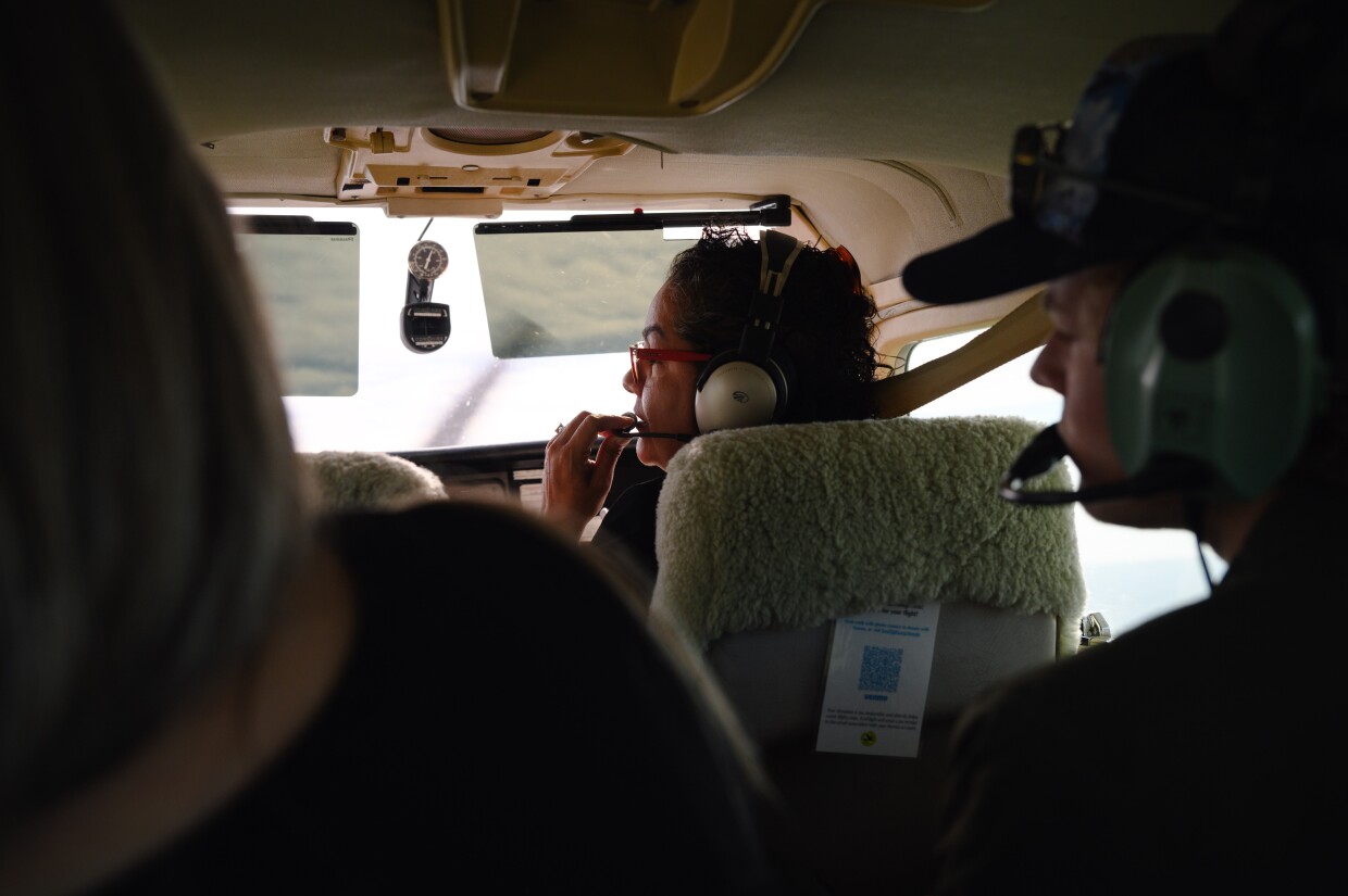 Sendy Hernández Orellana Barrows, conservation program manager for Consejo de Federaciones Mexicanas, shares background information with passengers as they look out over the proposed Chuckwalla National Monument on the edge of Imperial and Riverside County during a flyover on Feb. 15, 2024.