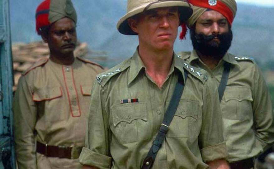 Tim Pigott-Smith (center) as Ronald Merrick, District Superintendent of Police.