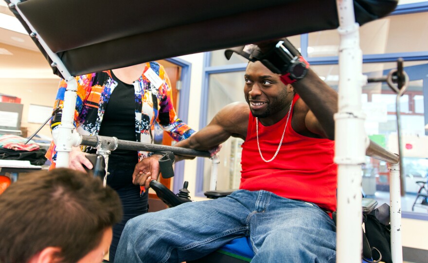 Nnaka prepares to get into a "stander." The device puts him into a standing position, which allows him to bear weight during his workout.