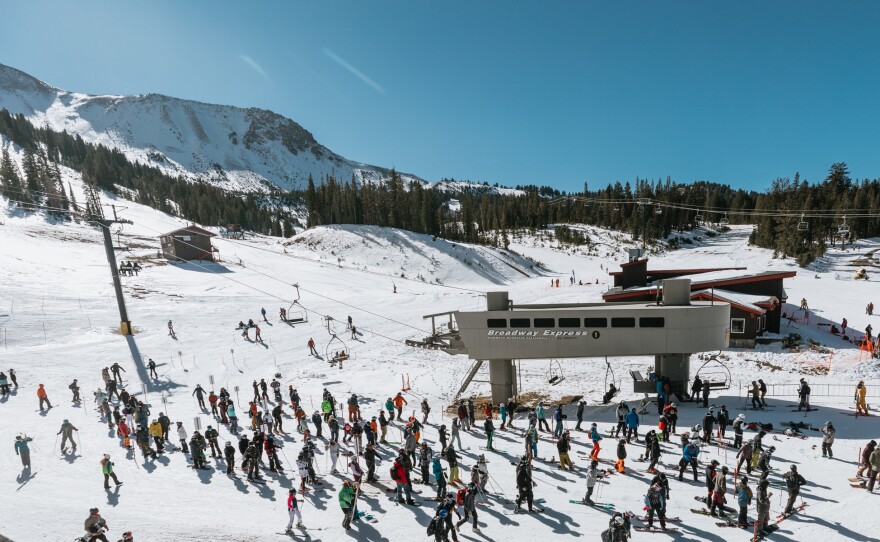 Skiers and snowboarders wait in a socially distanced lift line at Mammoth Mountain on Nov. 15.