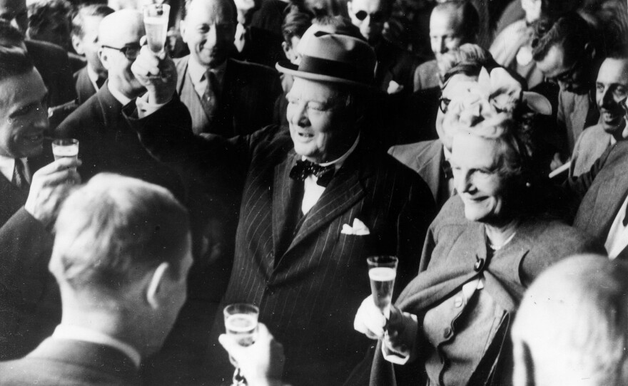 British politician Winston Churchill and his wife, Clementine, make a toast upon their arrival in Switzerland in August 1946. Stories of Churchill's special relationship with alcohol are legendary — and champagne was his truest passion. A new book reveals the extent to which that passion imperiled his already threadbare bank balance.