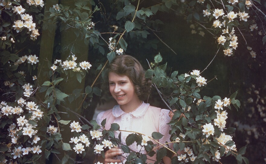 July 8,1941: Princess Elizabeth amongst a syringa bush in the grounds of Windsor Castle, Berkshire.
