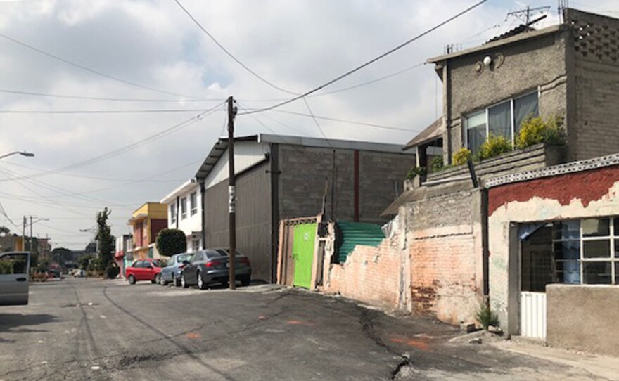A large crack cuts through this Mexico City street. Half of the street is lower than the other half, one of many signs this metropolis is sinking.