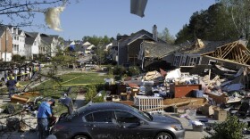 A home on Serendipity Drive is flattened to the foundation as the home next to it, still with a partial roof, slid down a hill in the McKinley Mill subdivision on April 17, 2011 in Raleigh, North Carolina. 