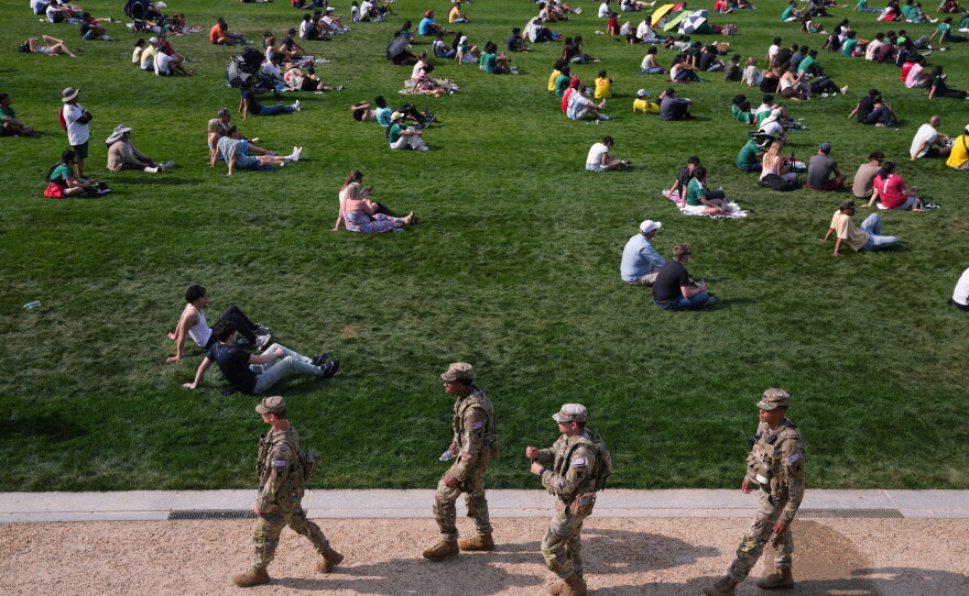 Members of the National Guard patrol as fans gather to watch the first match of the World Cup between Mexico and South Africa on the National Mall in early June.