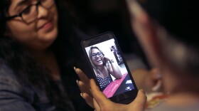 Steve Stegall shares the phone with his stepdaughter, Jennifer Tadeo-Uscanga, while making a video call with his wife and Jennifer's mother, Letty Stegall, at their Kansas City, Mo., home on Thursday, May 24, 2018. 