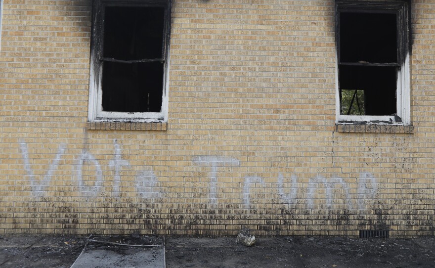 "Vote Trump" graffiti was painted on the side of the church in Greenville, Miss., shown Wednesday. Fire Chief Ruben Brown tells The Associated Press that firefighters found flames and smoke pouring from the sanctuary of the church Tuesday night.