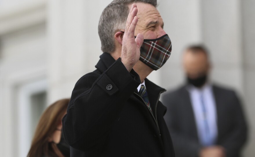Thursday, Jan. 7, 2021, Republican Gov. Phil Scott wears a mask as he takes the Oath of Office on the steps of the Vermont Statehouse in Montpelier, Vt., beginning his third two-year term. Vermont is one of two states that holds elections for governor every two years.