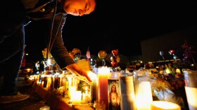 People light candles at a makeshift memorial that continues to grow in front of University Medical Center, for those killed and wounded during an attack on U.S. Rep. Gabrielle Giffords (D-AZ) on January 11, 2011 in Tucson, Arizona.