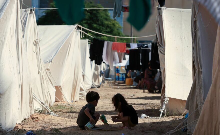 Children play among tents set up for Palestinians seeking refuge on the grounds of an UNRWA center in Khan Younis in the southern Gaza Strip on Oct. 19.