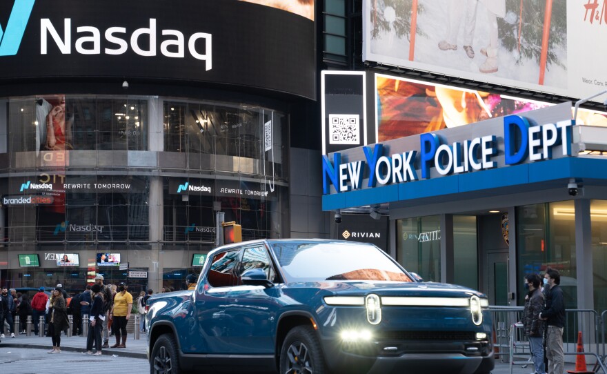 A Rivian R1T electric pickup truck is displayed outside the Nasdaq MarketSite in Times Square, New York, on Nov. 10. Shares in the electric truck maker gained strongly in their first day of trading after completing its IPO.