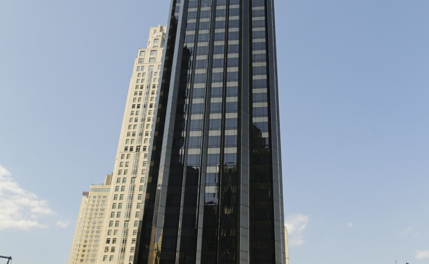 Cars pass the Trump International Hotel & Tower building.