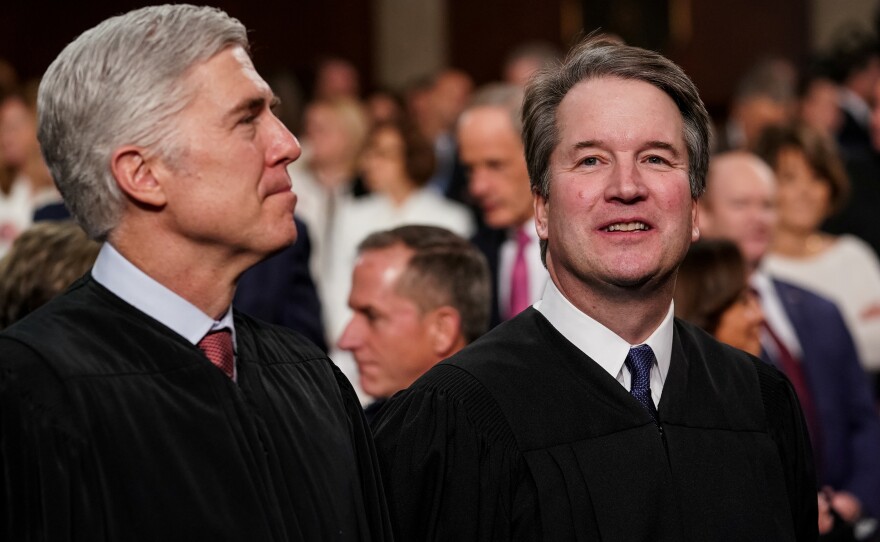 Supreme Court Justices Neil Gorsuch (left) and Brett Kavanaugh wrote opposing opinions in a high-profile case involving Apple's App Store. The two Trump appointees are seen here at the Capitol in February.