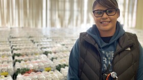 Dot Thurby with some of the thousands of water bottles the Confederated Tribes of Warm Springs distributes to members every day.